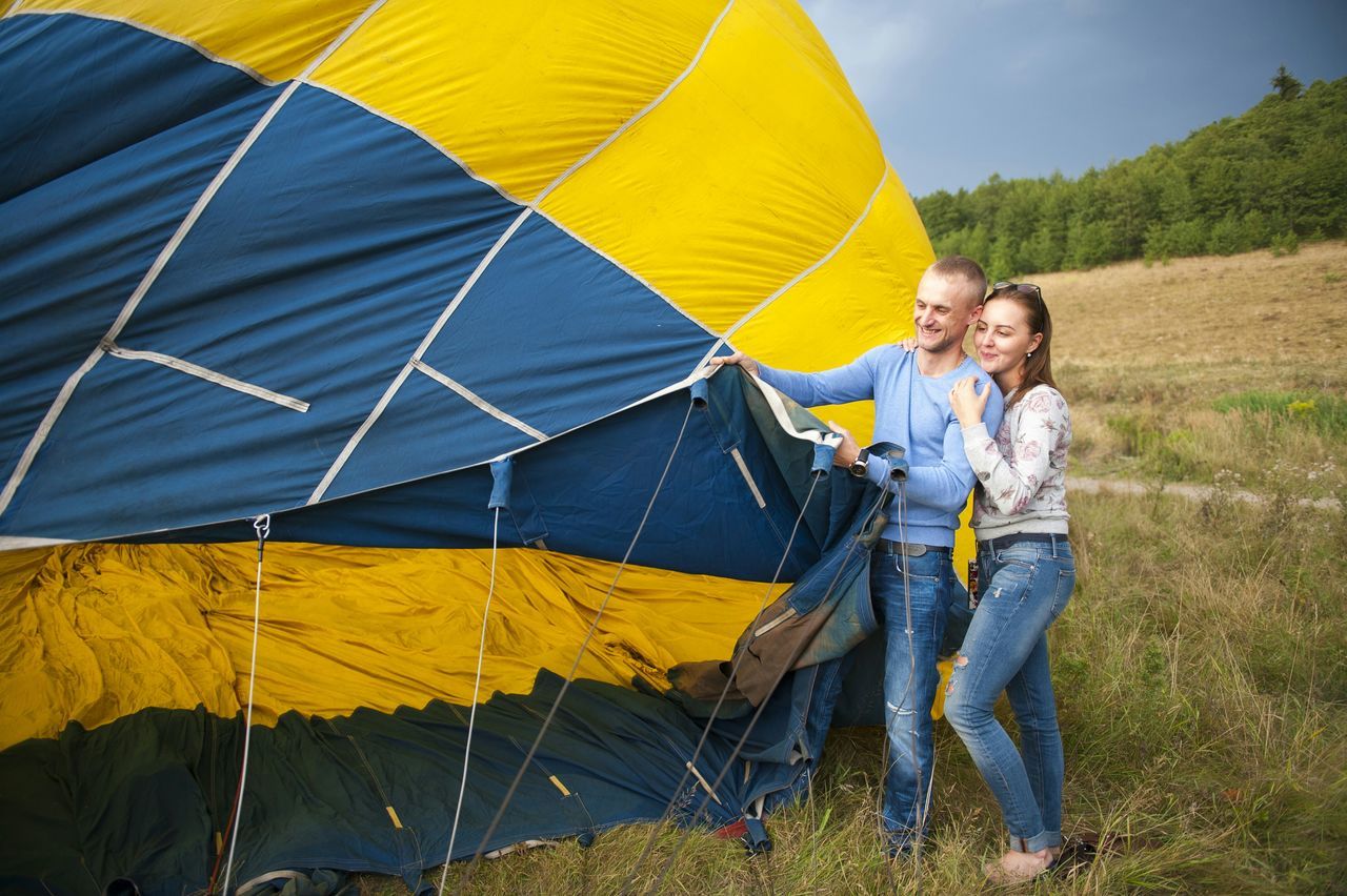 lifestyles, leisure activity, casual clothing, field, person, yellow, full length, childhood, boys, fun, sky, men, landscape, standing, holding, day, outdoors