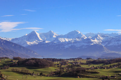 Scenic view of snowcapped mountains against clear sky