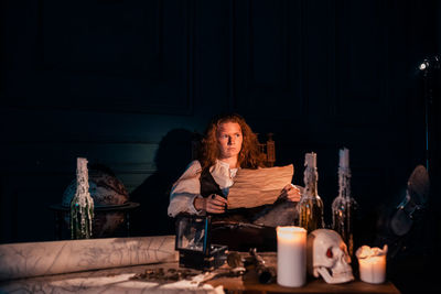 Woman sitting on table at home