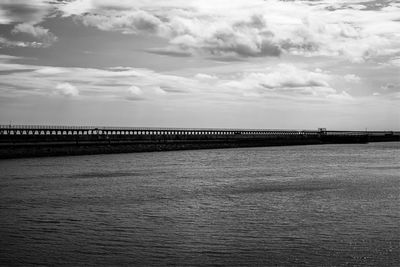Bridge over sea against sky