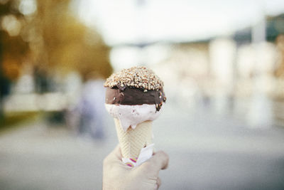 Close-up of hand holding ice cream cone