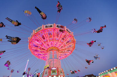 Low angle view of amusement park ride against sky