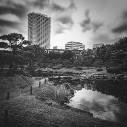 Buildings in city against cloudy sky