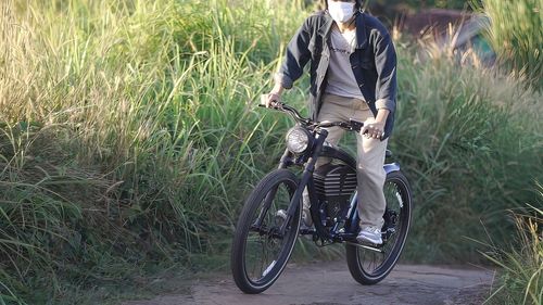 Man riding bicycle on field
