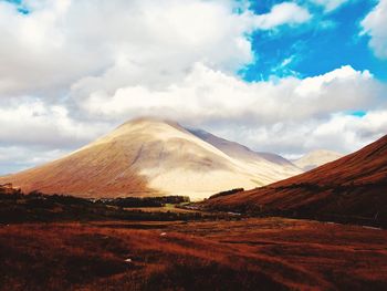 View of volcanic landscape against cloudy sky