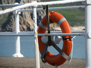 Close-up of umbrella by railing