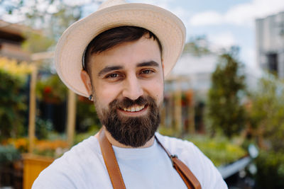 Close-up portrait of male florist looking at camera.