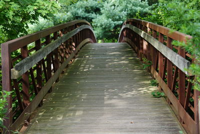 Wooden arched footbridge in summer