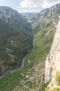 High angle view of valley and mountains against sky