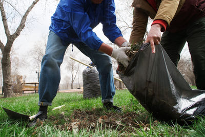 Low section of men working on field