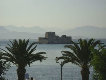 Calm sea with mountain in background