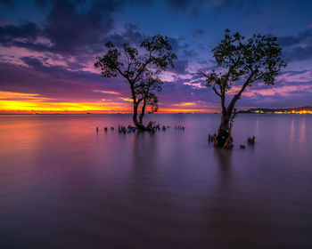 Scenic view of sea against romantic sky at sunset