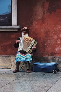 Full length of man standing against wall