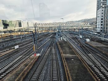 High angle view of railroad tracks in city against sky