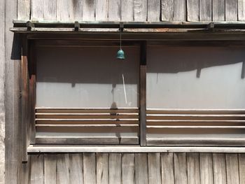 Close-up of clothes drying against wooden wall