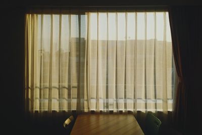 Empty chairs and table by window at home