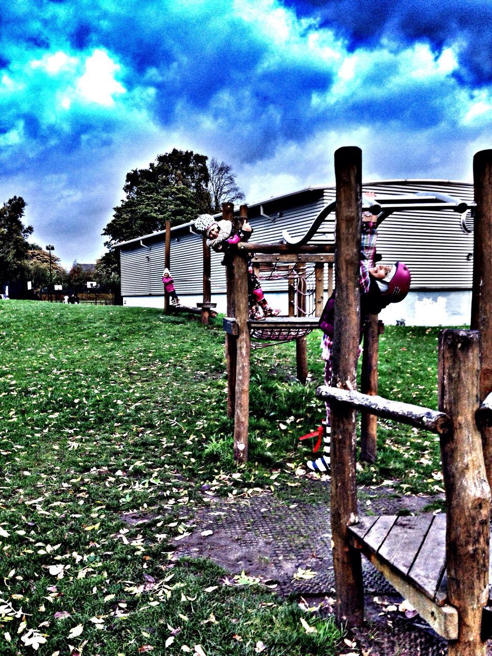 sky, cloud - sky, grass, cloudy, field, tree, cloud, wood - material, fence, abandoned, built structure, nature, tranquility, day, outdoors, grassy, landscape, playground, no people, safety