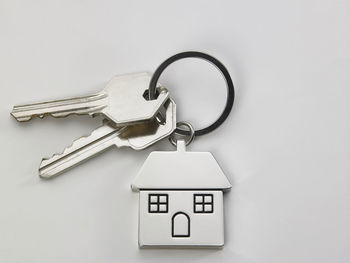 Close-up of house keys over white background