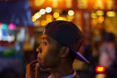 Portrait of young man looking away outdoors