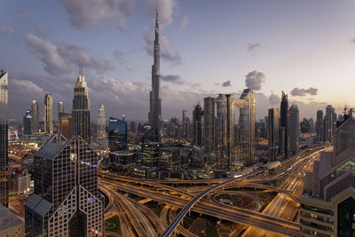 Aerial view of buildings against cloudy sky