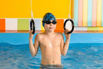 Shirtless boy in swimming pool