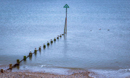 Street light on sea by footpath