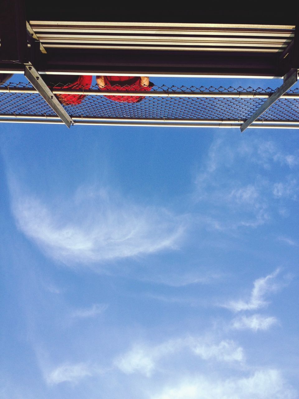 low angle view, sky, cloud - sky, cloud, blue, built structure, architecture, flag, day, pole, cloudy, no people, outdoors, identity, national flag, patriotism, building exterior, connection, american flag, nature