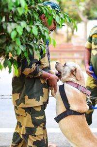 Side view of army soldier with dog