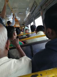 Rear view of people sitting in bus