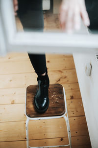 Low section of person standing on table