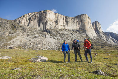 Three mountaineers pose for a photo before beginning a multi-day trek.