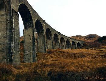 Low angle view of arch bridge against clear sky