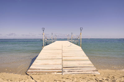 Pier over sea against clear sky