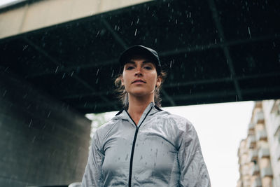 Portrait of woman standing in rain