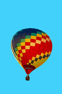 Low angle view of hot air balloon against clear blue sky