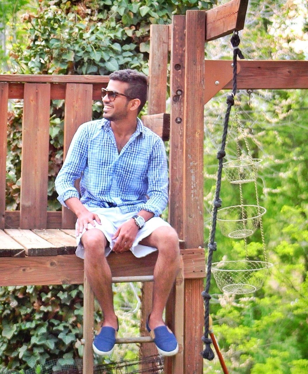 casual clothing, person, lifestyles, wood - material, leisure activity, young adult, tree, standing, three quarter length, wooden, railing, full length, front view, sitting, built structure, wood, young men, smiling