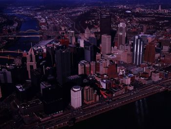 High angle view of city lit up at night