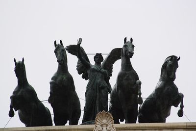 Low angle view of sculpture against clear sky