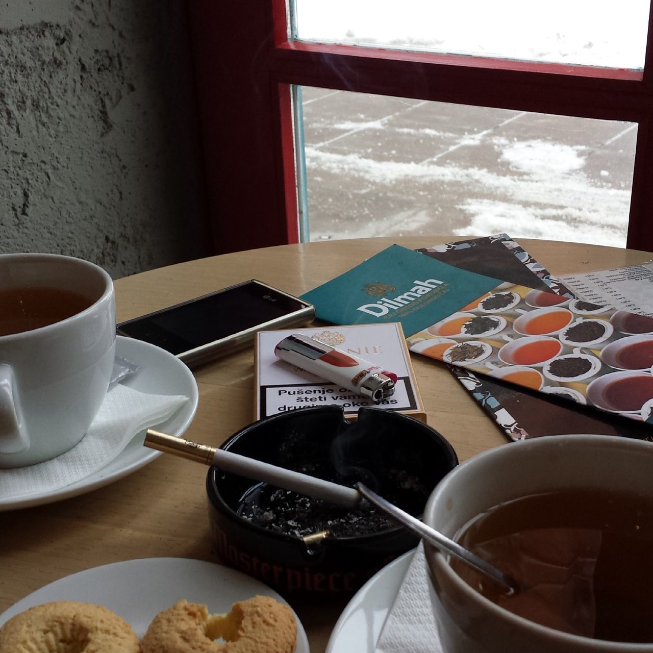 indoors, coffee cup, food and drink, drink, table, coffee - drink, refreshment, cup, freshness, coffee, still life, saucer, window, plate, tea cup, chair, breakfast, spoon, home interior, tea