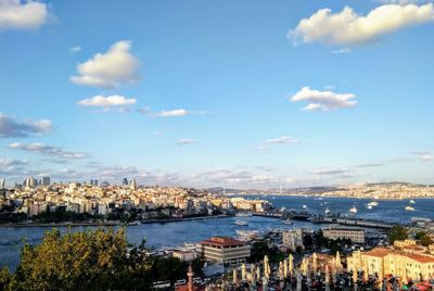 High angle view of townscape by sea against sky