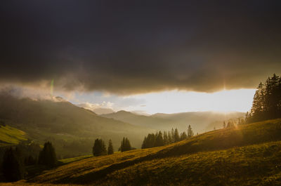 Scenic view of mountains against cloudy sky