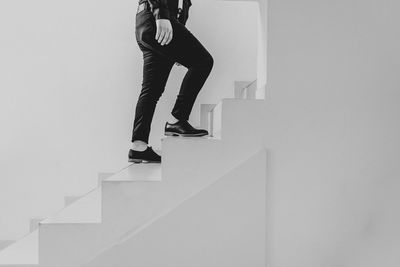 Low section of woman standing on staircase