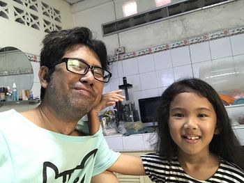 Portrait of smiling young man holding eyeglasses