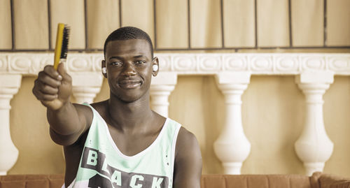 Portrait of young man sitting on sofa