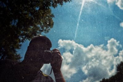 Close-up of woman against sky