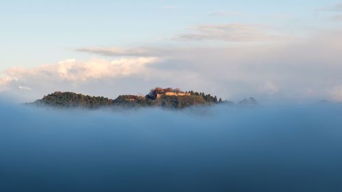 Panoramic view of tree and mountains against sky