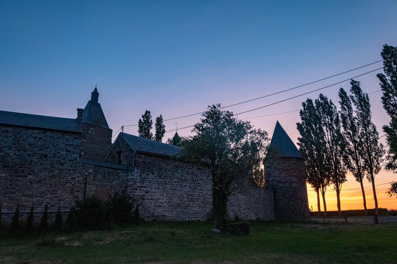 architecture, sky, built structure, building, building exterior, plant, nature, tree, history, house, the past, no people, place of worship, blue, landscape, religion, clear sky, sunset, travel destinations, grass, dusk, outdoors, rural scene, residential district, evening, belief, land, castle, travel, old