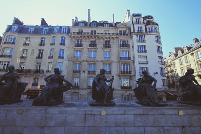 Group of people in front of building against sky