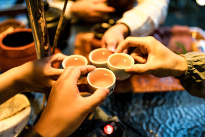 Midsection of man holding coffee cup