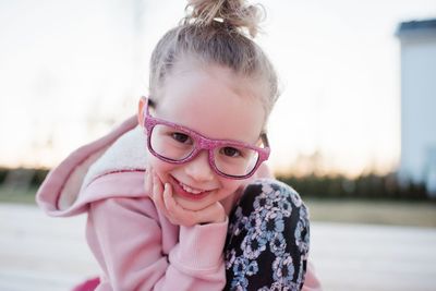 Portrait of a young girl with sparkly glasses on smiling